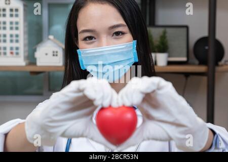 Lächelnder Weiblicher Arzt Mit Herzform Im Krankenhaus. Stockfoto