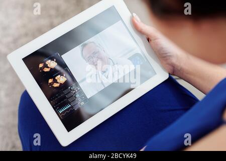 Schwangere Frau, die mit ihrem Gynäkologen eine Telemedizin-Sitzung hat Stockfoto
