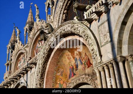 Venedig, Italien-Februar 2020; niedrige Winkelansicht des Eingangs und der Dachdetails der Markusbasilika; die Domkirche der römisch-katholischen Erzdiözese Stockfoto