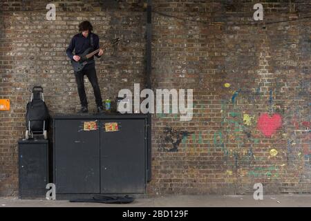 Busker spielt Gitarre, Chalk Farm Road, Camden Town, London, Großbritannien Stockfoto