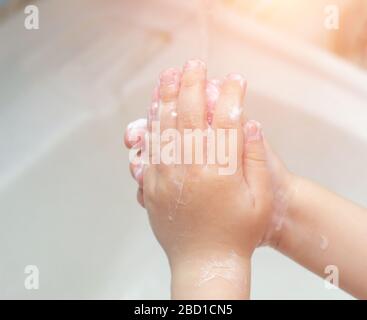 Ein Kind wäscht seine Hände mit Seife im Bad. Das Konzept der Hygiene und saubere Hände, Infektion, close-up Stockfoto