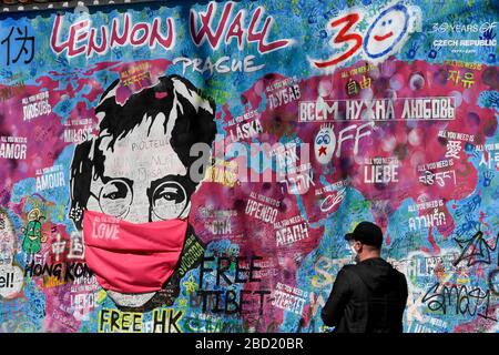 Prag, Tschechien. April 2020. Eine Schutzmaske gegen Coronavirus erhielt auch ein Porträt des Sängers John Lennon an der Lennon-Wand auf der Kampa-Insel in Prag, Tschechien, das am 6. April 2020 abgebildet war. Credit: Ondrej Deml/CTK Photo/Alamy Live News Stockfoto