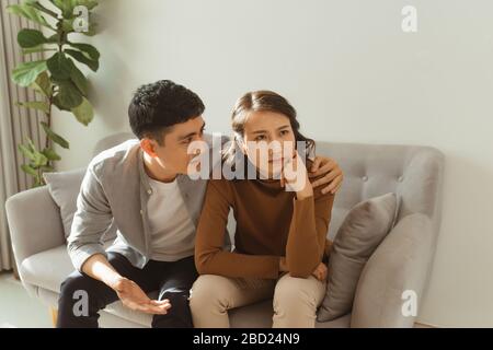 Der junge Mann hilft, das Problem zu überwinden und unterstützt die unglücklich reife Frau zu Hause Stockfoto