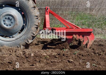 Landwirt Kultiviert Obstgarten Mit Traktor Stockfoto
