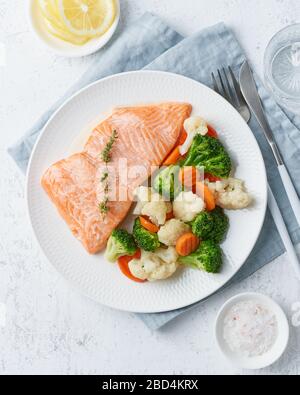 Dampflachs und Gemüse, Paleo, Keto, Fodmap, DASH-Diät. Mediterrane Küche mit Fisch Stockfoto