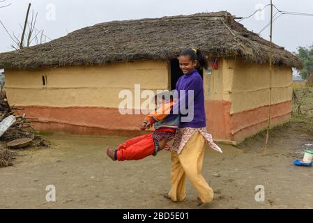 Chitwan, Nepal - 21. Januar 2020: Kinder vor ihrem traditionellen ländlichen Haus in Chitwan auf Nepal Stockfoto