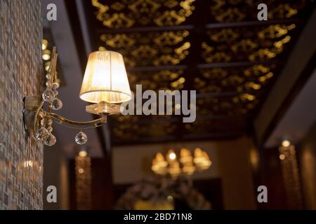 Vintage Wandleuchte . Glühbirnendesign im Vintage-Stil an der Wand . Antiklampe . Nahaufnahme von Vintage-Licht an der Wand . Die Lampe leuchtet im Dunkeln. Stockfoto