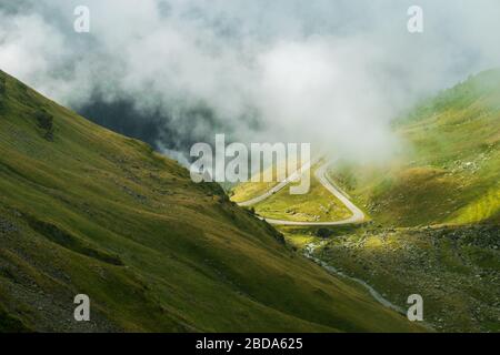 Die Straße, die die Fagaras Berge von oben gesehen im Nebel, Transfagarasan, Rumänien überquert Stockfoto