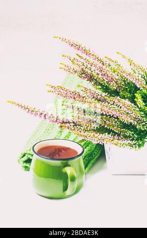 Bouquet aus Heidekraut, Teebecher und Strickschal, selektiver Fokus Stockfoto