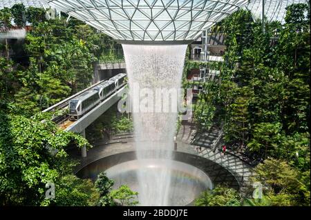 28.03.2020, Singapur, , Singapur - Forest Valley mit HSBC Rain Vortex Wasserfall im neuen Jewel Terminal am Changi International Airport. Das Desi Stockfoto