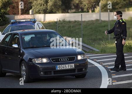 Barcelona, Spanien. April 2020. Ein Polizeibeamter kontrolliert den Verkehr an einem der Kontrollpunkte außerhalb Barcelonas.mit der Ankunft von Ostern hat sich die Polizeikontrolle erhöht, um zu verhindern, dass Menschen in Zweitwohnungen gehen. In den letzten Tagen haben die Behörden einen Anstieg des Wasser- und Energieverbrauchs in den ländlichen Gebieten angeprangert. Credit: SOPA Images Limited/Alamy Live News Stockfoto