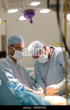 Chirurgen und Krankenschwestern führen eine Magenoperation in einem NHS-Krankenhaus durch. Die NHS steht wegen der Unterfinanzierung durch die Regierung unter Druck. Stockfoto