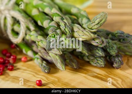Frischer junger Asparagus-Nahkampf. Spargel auf Holzbrett Stockfoto