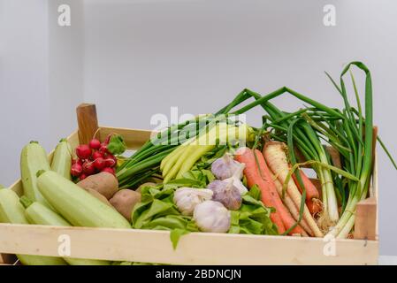 Serbisches Bio-Gemüse in einer traditionellen Holzkiste auf einem gesunden Lebensmittelstand Markt für gesunde Salatgerichte vorbereitet werden Stockfoto