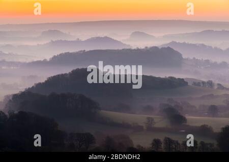 Bridport, Dorset, Großbritannien. April 2020. Wetter in Großbritannien. Nebel in den Tälern umgibt die Hügel von Bridport in Dorset bei Sonnenaufgang vor einem weiteren warmen sonnigen Frühlingstag. Bildnachweis: Graham Hunt/Alamy Live News Stockfoto