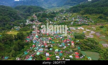 Die Stadt ist umgeben von Bergen, eine Sicht von oben. Sagada Stadt auf der Insel Luzon, Philippinen. Die Häuser und Straßen der Bergstadt. Dorf in der Cordillera Gebirge. Stockfoto