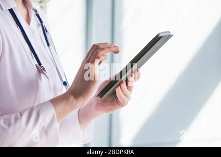 Ärztin, die auf einem Tablet-Computer arbeitet Stockfoto