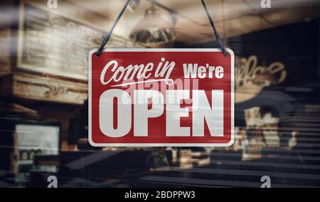 Ein Schild, das auf dem Fenster des Cafés/Restaurants „Come in We're Open“ steht. Stockfoto