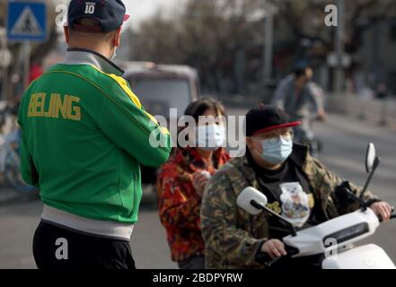 Peking, China. April 2020. Chinesen, die Schutzmasken tragen, fahren am Donnerstag, 9. April 2020 in Peking mit dem Fahrrad. Chinas Hauptstadt bremst die Rückkehr zu einem "normalen" Leben von drakonischen Sicherheitsmaßnahmen aufgrund des Covid-19-Ausbruchs, da die Regierung langsam einige Einschränkungen für Reisen und soziale Interaktionen aufhebt. Foto von Stephen Shaver/UPI Credit: UPI/Alamy Live News Stockfoto