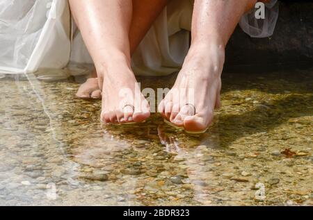 Ringe auf den Zehen eines frisch verheirateten Paares platziert Stockfoto