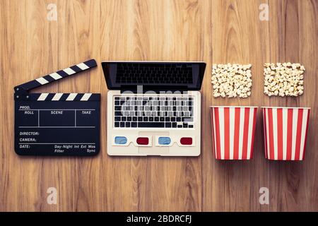 Laptop, Klappe, Popcorn und 3D-Brille: Kino streaming und Film online-Serienkonzept Stockfoto
