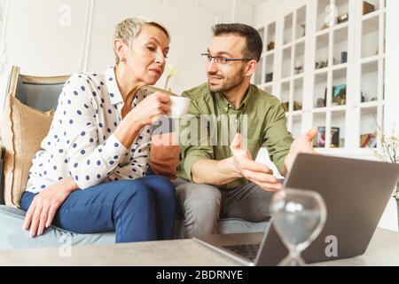 Freute Wahrsagerin, die eine seriöse Dame anblickt Stockfoto