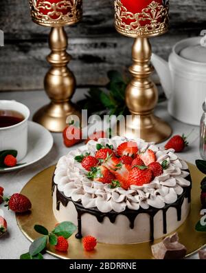 Schokolade Dipping Kuchen mit Erdbeerscheiben gekrönt Stockfoto