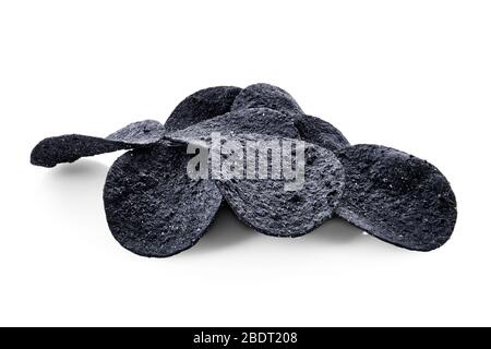 Schwarze knusprige würzige Kartoffelchips auf weißem Hintergrund mit voller Schärfentiefe isoliert Stockfoto