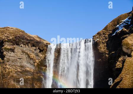 Skogafoss Wasserfall im Südwesten Islands mit einem Regenbogen Stockfoto