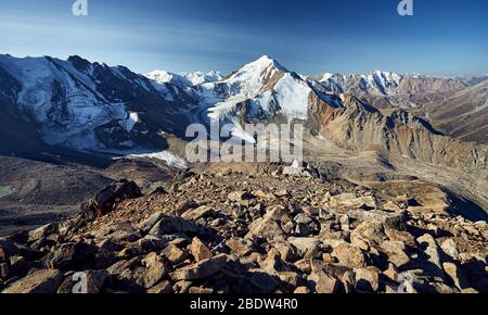 Dankbar schneebedeckten Mount sovetov zwischen Felsen Silhouette bei Sonnenaufgang in Tyan Shan Gebirge in Kasachstan Stockfoto