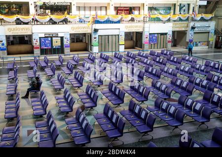 BANGKOK, THAILAND: Ein Mann sitzt allein in einem Wartebereich in Hua Lamphong, Bangkok Railway Station, wo Stühle mit XS markiert wurden, damit Menschen inmitten der COVID-19 Coronavirus Ängste am 6. April 2020 in Thailand soziale Distanz üben können. Stockfoto