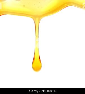 Honig oder goldene Flüssigkeit auf weißem Hintergrund gießen Stockfoto