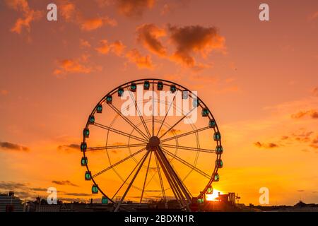 Riesenrad bei Sonnenuntergang, buntes Himmel und Riesenrad. Stockfoto