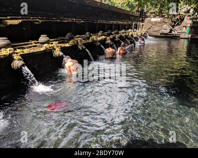 23. APRIL 2019-BALI INDONESIEN: Menschen, die in Brunnen heiligen Wassers in Tirta empul Tempel baden. Religion und Kultur. Stockfoto