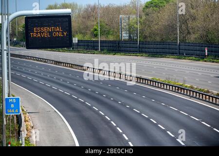 Hinweisschilder mit der Aufschrift „Essential Travel Only“ auf der M5 in der Nähe von Bristol, da staatliche Beschränkungen weiterhin versuchen, das Coronavirus einzudämmen. Stockfoto