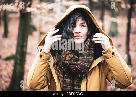Natürliche Mädchen in Winter Jacke lächelt in goldenen Bronze Herbst Wald Stockfoto