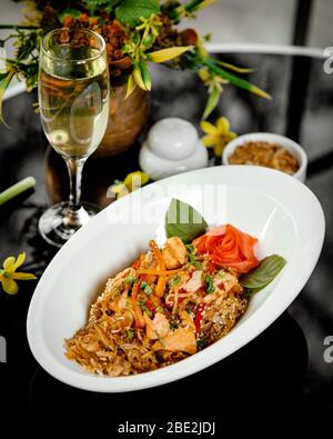 Eine Schüssel mit Hühnernudel mit Gemüse und Sesam Stockfoto