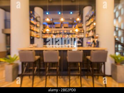 Halb beleuchtete Halle im Loft-Stil in einem städtischen Café mit offener Bar Stockfoto