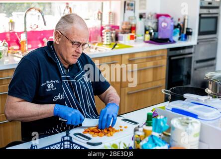 Harrogate, North Yorkshire, Großbritannien. April 2020. Leben im Lockdown. Paul Welch hat 450 Mahlzeiten für Menschen in Not gekocht. Bisher hat er 35 kg Zwiebeln gehackt, 20 kg Hackfleisch gebraten und 5 kg Tomatenkonzentrat verwendet! Dank der Covid Cooperation Gruppe wurden bereits 300 dieser Mahlzeiten an Ärzte, Obdachlose und Bedürftige verteilt. Paul hat zwei Töchter, die Ärzte vor Ort sind, eine in der Intensivstation und eine in A&E und er hat sie auch gefüttert. Pauls Leidenschaft für das Kochen begann nach einem Unfall vor 20 Jahren, der ihn im Rollstuhl gefesselt ließ. Kredit: ernesto rogata / Alamy Live News Stockfoto