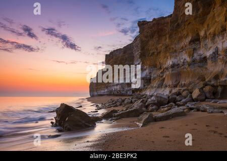 Burton Bradstock, Dorset, Großbritannien. April 2020. Wetter in Großbritannien. Die senkrechten Sandsteinklippen am Hive Beach am Burton Bradstock in Dorset am Ende eines heißen sonnigen Tages. Bild: Graham Hunt/Alamy Live News Stockfoto