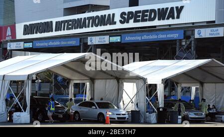 Daytona, USA. April 2020. Mitarbeiter im Gesundheitswesen von AdventHealth bieten am 11. April 2020 auf dem Daytona International Speedway in Daytona Beach, Florida, Drive-Thru-COVID-19-Tests an. Die Ergebnisse des Speicheltests werden in 2-3 Tagen vorliegen. Kredit: Paul Hennessy/Alamy Live News Stockfoto