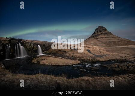 Nordlichter aurora borealis über dem Wasserfall Kirkjufell in Island Stockfoto