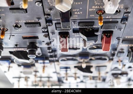 Nahaufnahme von vielen Schaltern in einem Flugzeugcockpit mit flachem Fokus Stockfoto