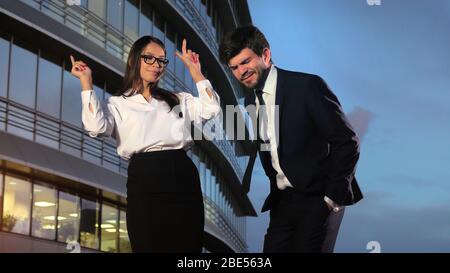 Weibliche und männliche Geschäftsleute tanzen und genießen die Musik im Bürogebäude. Stockfoto