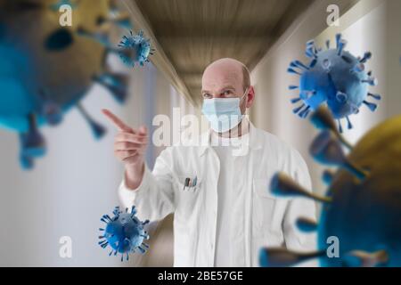 Konzept der Verhinderung der Ausbreitung der Epidemie und Behandlung von Coronavirus: Ein kaukasischer Arzt mit einer Schutzmaske zeigt auf gerenderte Corona-Virus um ihn herum im Korridor eines Krankenhauses. Stockfoto