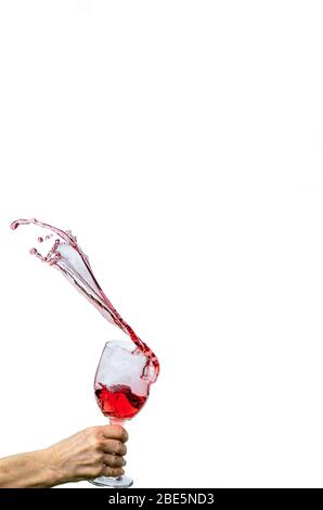 Wein spritzt aus Weinglas Stockfoto