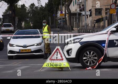 Jerusalem, Israel. April 2020. Eine israelische Grenzpolizei trägt Schutzmaske und Handschuhe, während sie am Sonntag, den 12. April 2020, die Sperrung des Mea Shearim-Viertels in Jerusalem erzwingt. Die israelische Regierung entsendet eine Polizei von 1,000, um eine vollständige Schließung jüdischer religiöser Viertel mit der höchsten Rate von Coronavirus in Jerusalem durchzusetzen. Laut dem Gesundheitsministerium leben etwa 75 Prozent der Infizierten in Jerusalem in den ultraorthodoxen Vierteln. Foto von Debbie Hill/UPI Quelle: UPI/Alamy Live News Stockfoto