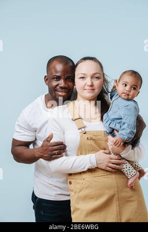 Glückliche junge Familie. Ehemann und Ehefrau mit ihrer kostbaren kleinen Tochter. Stockfoto