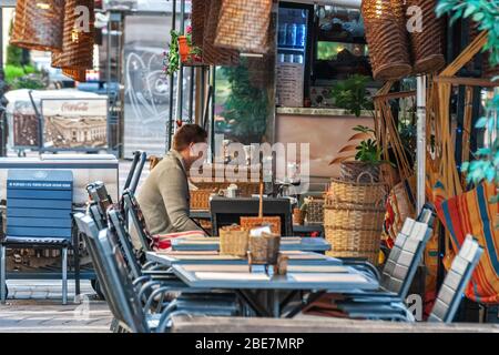 Sankt Petersburg, Russland, Juni 16: Ein Mann trinkt allein in einem Straßencafé am Newski Prospekt an einem Sommertag, dem 16. Juni 2016. Stockfoto