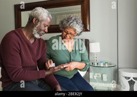 Ein afroamerikanisches Paar, das Zeit zusammen in ihrem Schlafzimmer verbringt Stockfoto